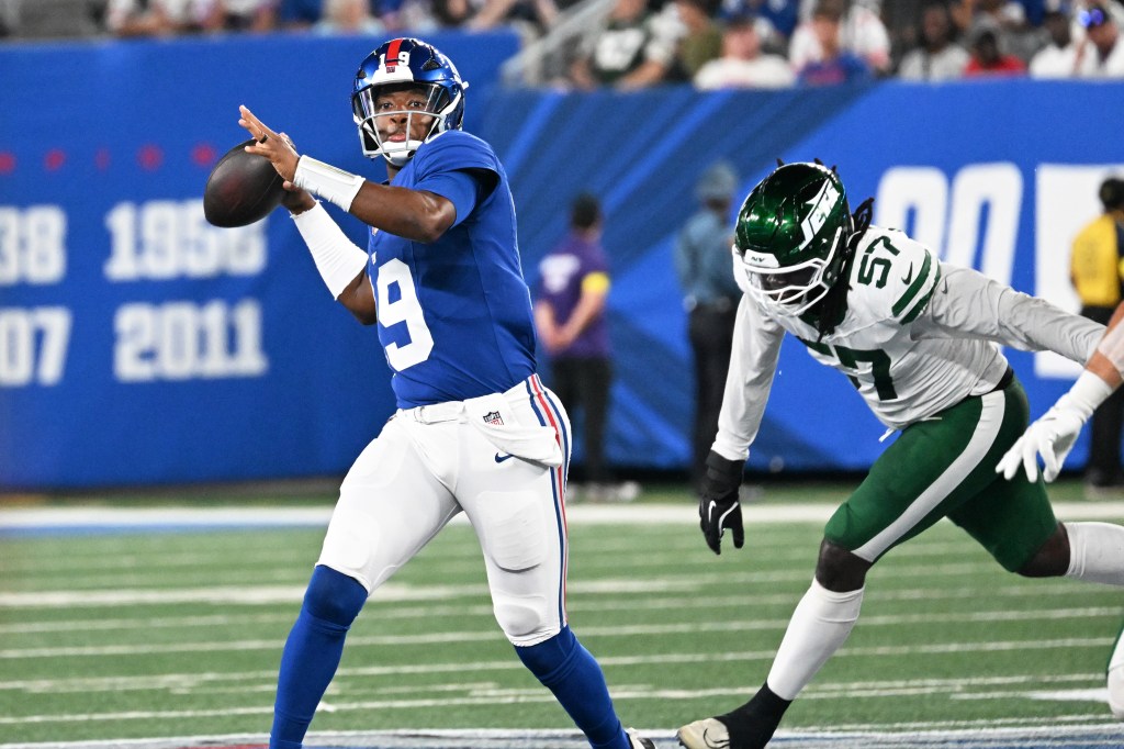 Giants quarterback throwing a football.