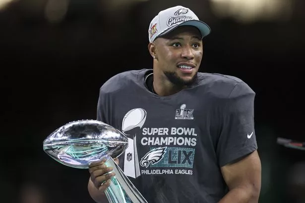 Saquon Barkley with the Super Bowl trophy