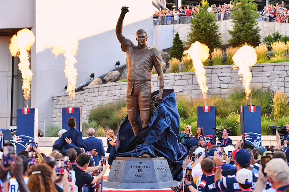 A bronze statue of former New England Patriots quarterback Tom Brady is unveiled in Patriot Place Plaza before an NFL preseason football game between the Washington Commanders and the New England Patriots Friday, Aug. 8, 2025, in Foxborough, Mass. (AP Photo/Steven Senne)