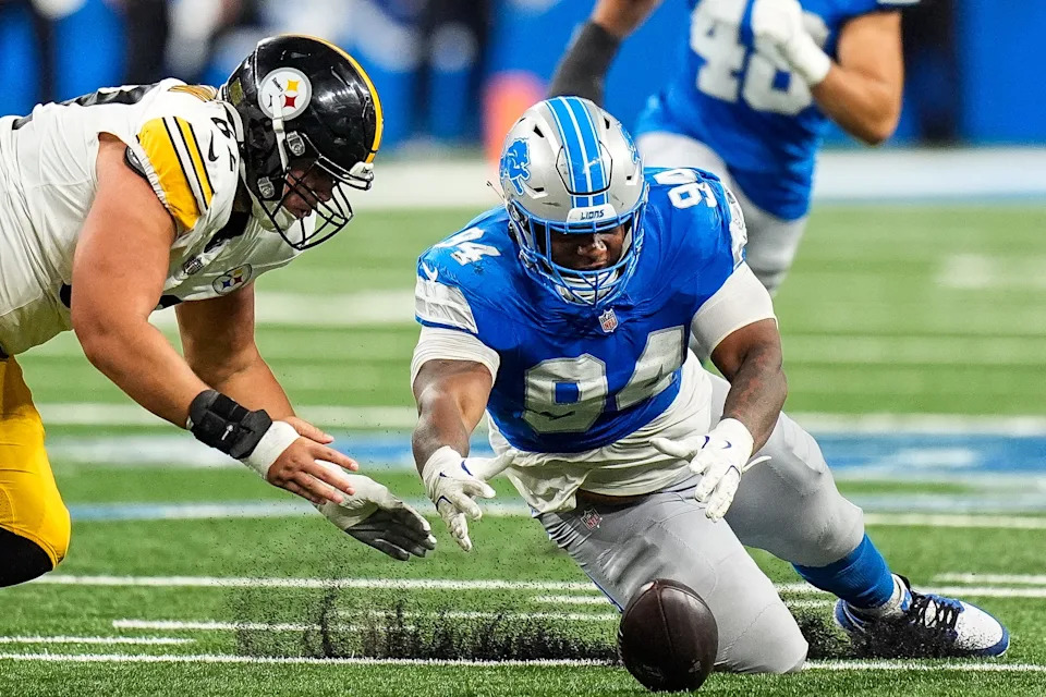 Detroit Lions defensive tackle Mekhi Wingo (94) picks up a fumble by Pittsburgh Steelers quarterback Kyle Allen (4) against Pittsburgh Steelers center Ryan McCollum (62) during the first half of a preseason game at Ford Field in Detroit on Saturday, August 24, 2024.