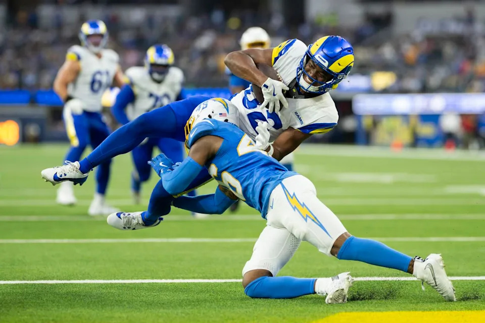 Rams wide receiver Tru Edwards scores a touchdown over Chargers cornerback Nikko Reed on Aug. 16.