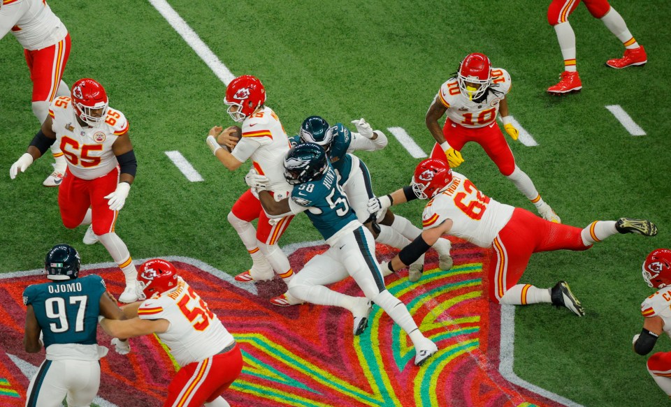 Patrick Mahomes of the Kansas City Chiefs being sacked by Philadelphia Eagles players.