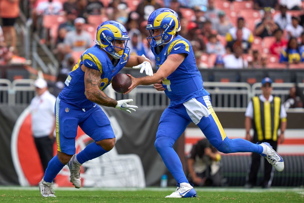 #4 hands the football to Cody Schrader #32 of the Los Angeles Rams during the NFL Preseason 2025 game against the Cleveland Browns at Huntington Bank Field on August 23, 2025 in Cleveland, Ohio. #4 hands the football to Cody Schrader #32 of the Los Angeles Rams during the NFL Preseason 2025 game against the Cleveland Browns at Huntington Bank Field on August 23, 2025 in Cleveland, Ohio.