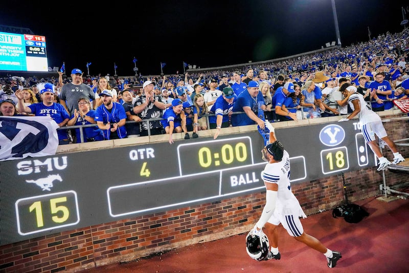 BYU safety Raider Damuni (3) celebrates with fans after a victory over SMU in an NCAA college football game Friday, Sept. 6, 2024, in Dallas.