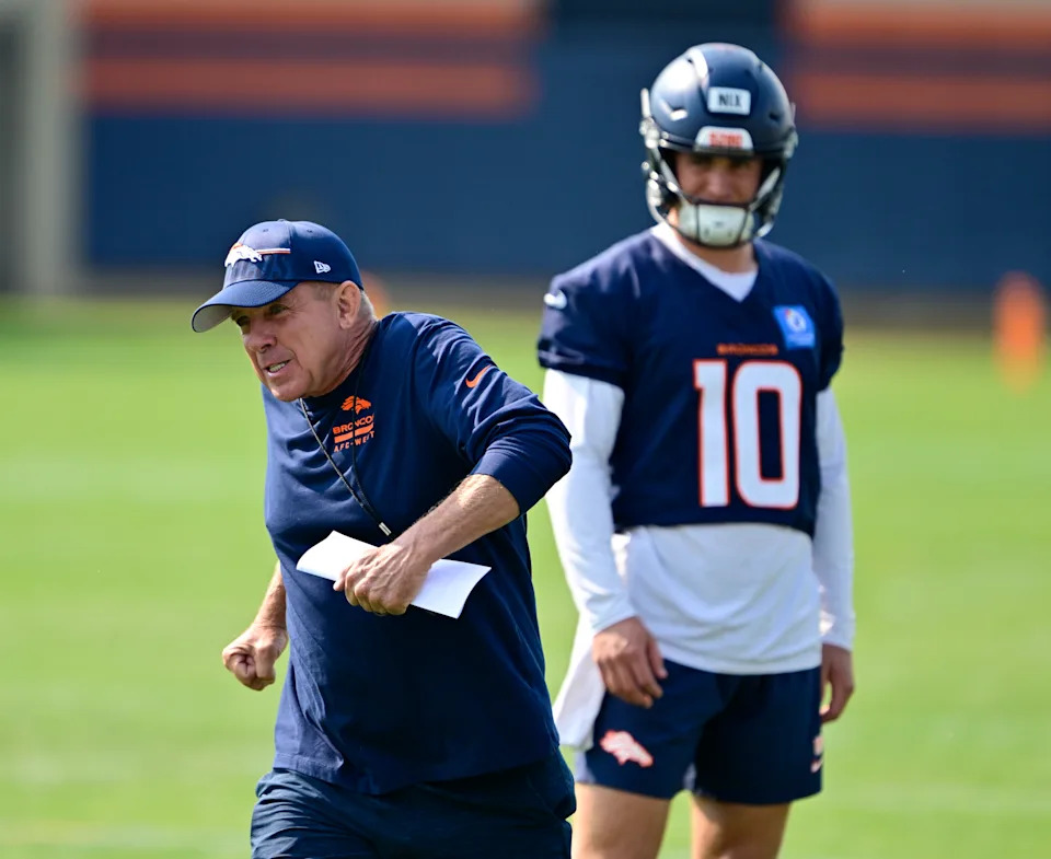 CENTENNIAL, CO - JULY 31: Denver Broncos head coach Sean Payton demonstrates a move for QB Bo Nix (10) during training camp at Broncos Park Powered by CommonSpirit in Centennial, Colorado, on Thursday, July 31, 2025. (Photo by Andy Cross/MediaNews Group/The Denver Post via Getty Images)