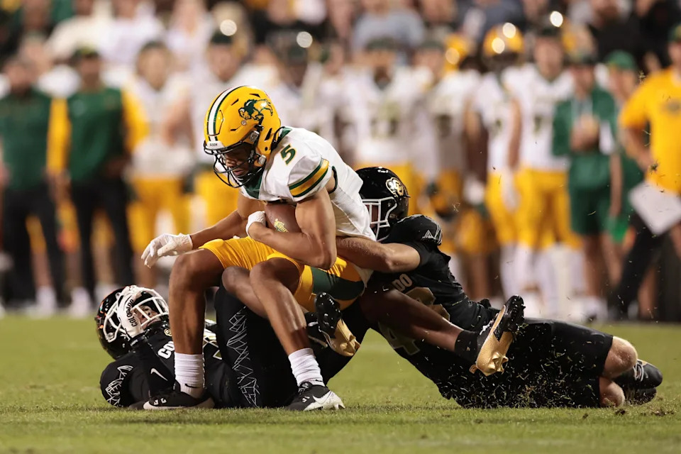 BOULDER, COLORADO - AUGUST 29: Bryce Lance #5 of the North Dakota State Bison is tackled by Trevor Woods #43 of the Colorado Buffaloes during the fourth quarter at Folsom Field on August 29, 2024 in Boulder, Colorado. (Photo by Andrew Wevers/Getty Images)