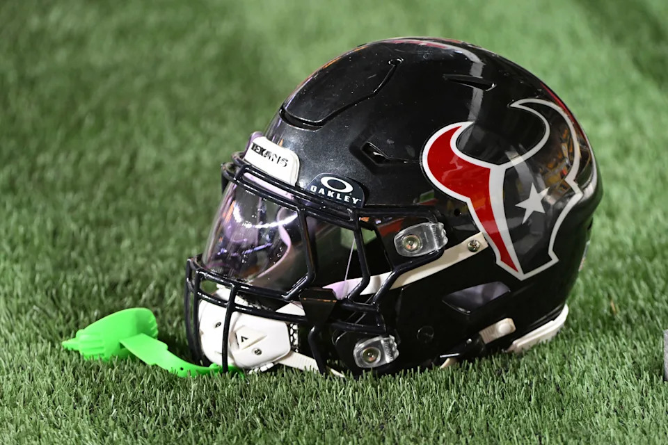 A Houston Texans helmet sits on the sidelines.