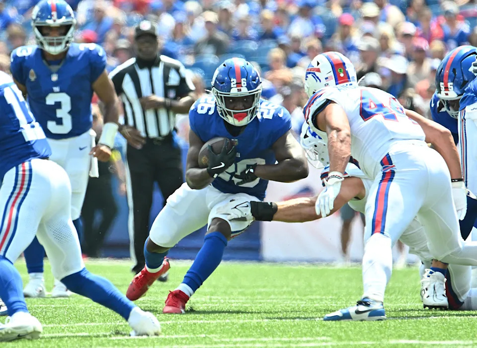 Aug 9, 2025; Orchard Park, New York, USA; New York Giants running back Devin Singletary (26) faces \Buffalo Bills linebacker Joe Andreessen (44) in the first quarter at Highmark Stadium. Mandatory Credit: Mark Konezny-Imagn Images