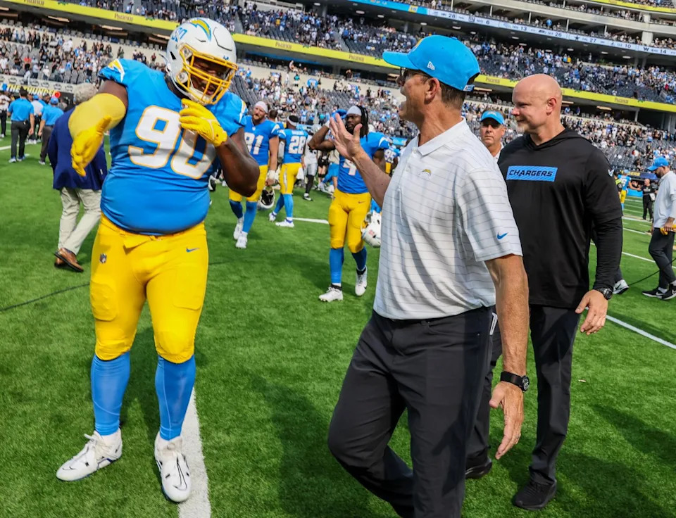 Chargers coach Jim Harbaugh congratulates defensive tackle Teair Tart after a win over the Raiders in September 2024.