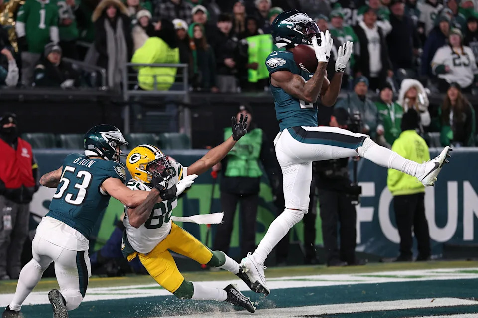 Jan 12, 2025; Philadelphia, Pennsylvania, USA; Philadelphia Eagles cornerback Quinyon Mitchell (27) makes an interception against the Green Bay Packers in an NFC wild card game at Lincoln Financial Field. Mandatory Credit: Bill Streicher-Imagn Images
