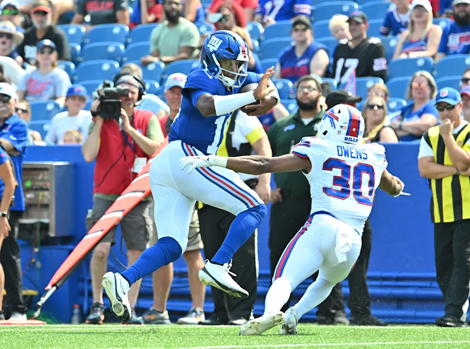 Aug 9, 2025; Orchard Park, New York, USA; New York Giants quarterback Jameis Winston (19) tries to avoid a tackle by Buffalo Bills safety Wande Owens (30) in the third quarter at Highmark Stadium. Mandatory Credit: Mark Konezny-Imagn Images