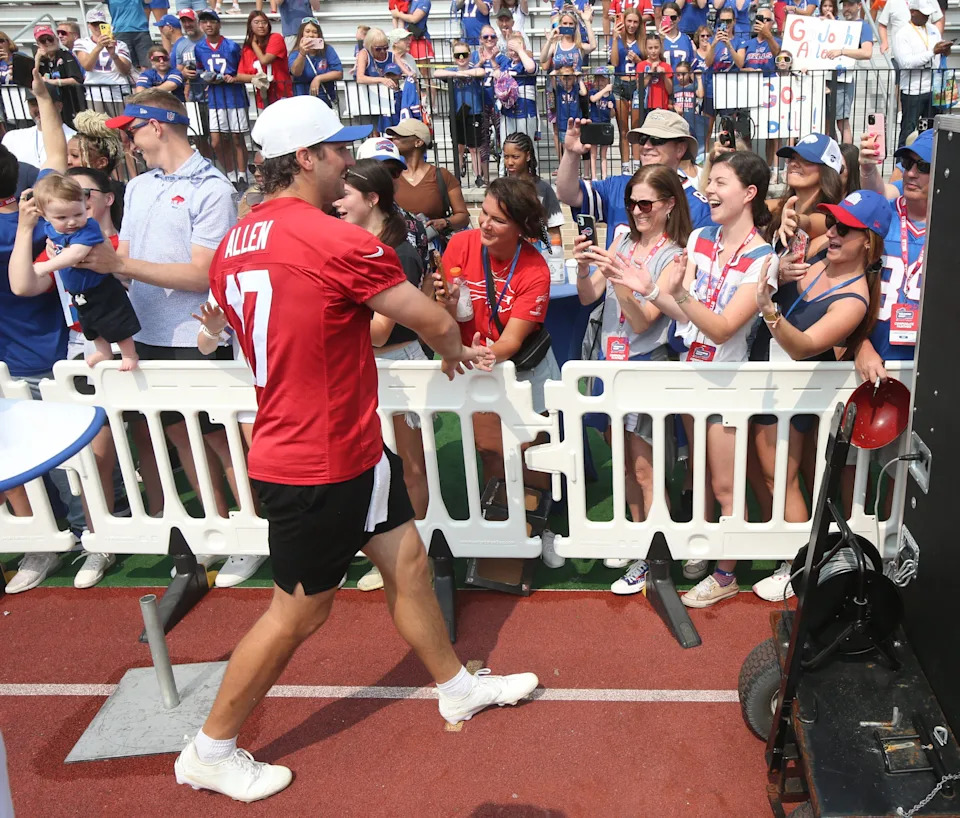 Bills quarterback Josh Allen runs the perimeter of the practice field high-fiving fans after practice during the final day of Buffalo Bills training camp at St. John Fisher University Thursday, August 7, 2025 in Pittsford, NY.