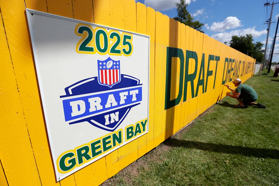 Matt Pecard of Green Bay touches up the newly painted Packers fence at 1177 Shadow Lane on Sept. 2, 2024, in Green Bay. The original Packers fence is 40 years old.