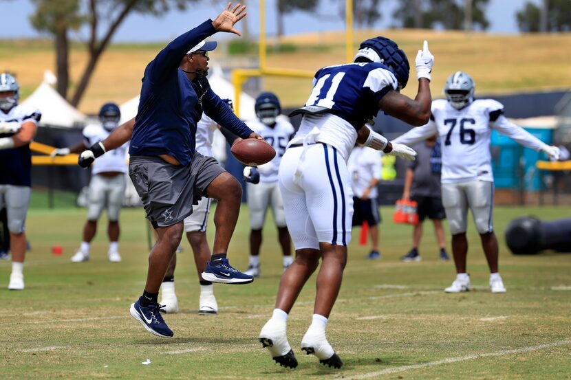 Dallas Cowboys defensive end Donovan Ezeiruaku (41) and assistant offensive line coach Ramon...