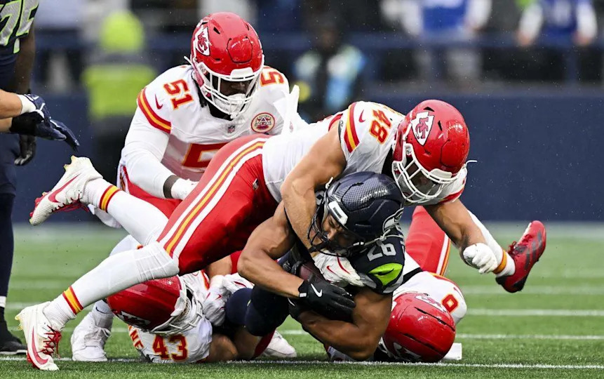 Seattle Seahawks running back Zach Charbonnet (26) is tackled on the run by Kansas City Chiefs linebacker Cole Christiansen (48) during the first quarter of the preseason game at Lumen Field, on Friday, Aug. 15, 2025, in Seattle.