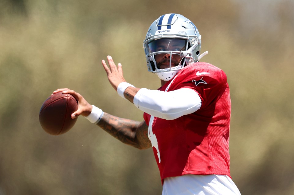 Dak Prescott throwing a football.