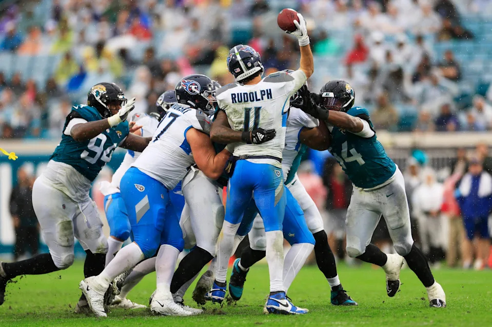Tennessee Titans quarterback Mason Rudolph (11) is pressured by Jacksonville Jaguars defensive end Travon Walker (44) during the second quarter of an NFL football matchup Sunday, Dec. 29, 2024 at EverBank Stadium in Jacksonville, Fla. [Corey Perrine/Florida Times-Union]