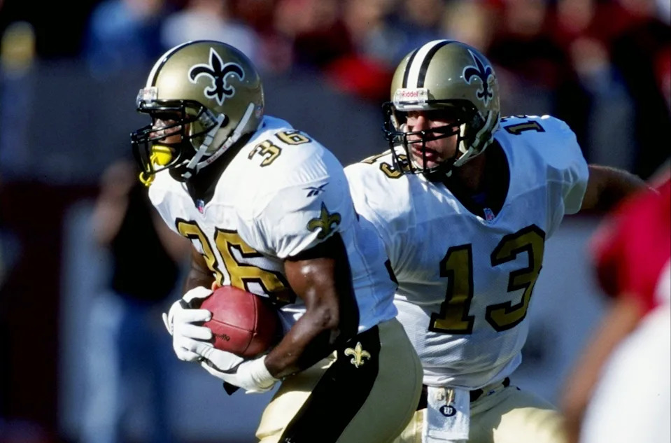 20 Dec 1998: Lamar Smith #36 of the New Orleans Saints running with the ball after he receives the hand off from the Quarterback Kerry Collins #13 during the game against the Arizona Cardinals at the Sun Devil Stadium in Tempe, Arizona. The Cardinals defeated the Saints 19-17.