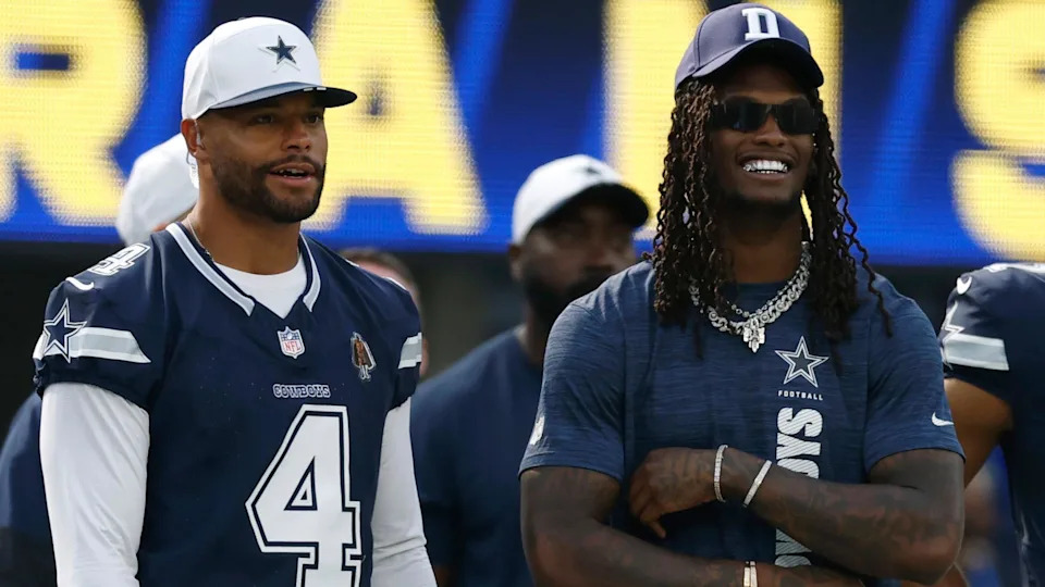 Dak Prescott and CeeDee Lamb of the Dallas Cowboys stands on the sidelines against the Los Angeles Rams