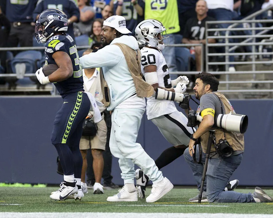 Seattle Seahawks running back George Holani (36) bounces off former Seahawks running back Marshawn Lynch after scoring a touchdown during the first quarter of the game against the Las Vegas Raiders at Lumen Field, on Thursday, Aug. 7, 2025, in Seattle, Wash. Brian Hayes/bhayes@thenewstribune.com