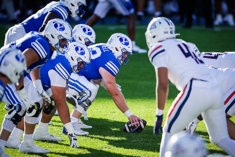 BYU center Bruce Mitchell prepares to snap the ball to quarterback Jake Retzlaff during the Cougars' victory over Arizona at LaVell Edwards Stadium in Provo on Saturday, Sept. 12, 2024.