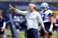 Dallas Cowboys head coach Brian Schottenheimer yells instruction to his quarterbacks during...