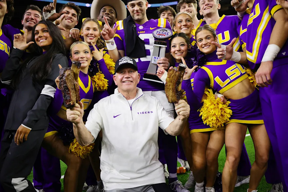 HOUSTON, TEXAS - DECEMBER 31: Head coach Brian Kelly of the LSU Tigers and Garrett Nussmeier #13 of the LSU Tigers pose with cheerleaders after defeating the Baylor Bears 44-31 in the Kinder's Texas Bowl at NRG Stadium on December 31, 2024 in Houston, Texas. (Photo by Alex Slitz/Getty Images)