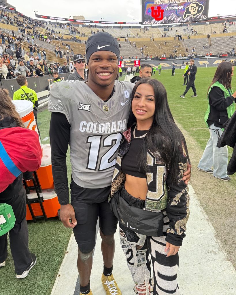travis hunter and wife leanna lenee on football field