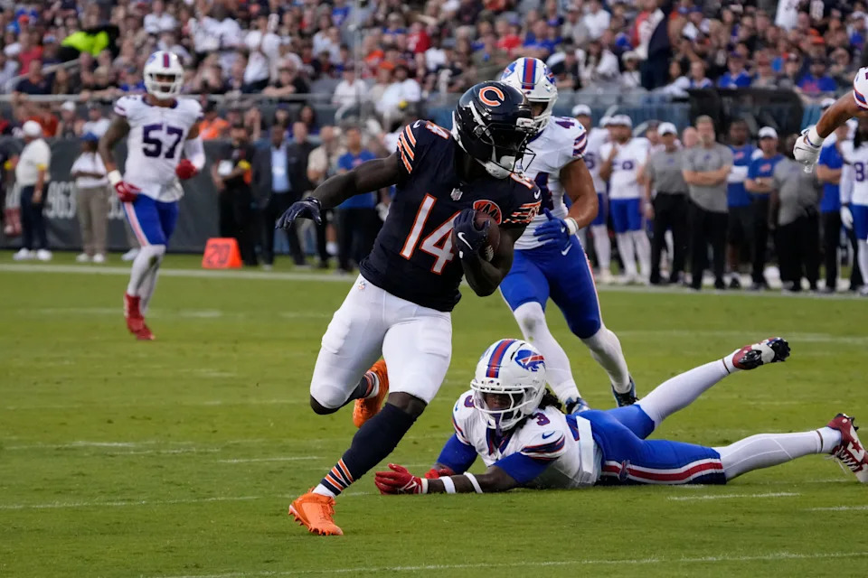 Aug 17, 2025; Chicago, Illinois, USA; Chicago Bears wide receiver Olamide Zaccheaus (14) catches a touchdown pass as Buffalo Bills safety Damar Hamlin (3) tries to tackle him during the first quarter at Soldier Field. Mandatory Credit: David Banks-Imagn Images