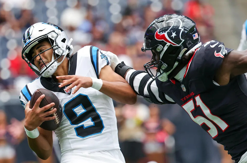 Aug 16, 2025; Houston, Texas, USA; Carolina Panthers quarterback Bryce Young (9) is tackled for a loss by Houston Texans defensive end Will Anderson Jr. (51) in the first quarter at NRG Stadium. Mandatory Credit: Thomas Shea-Imagn Images