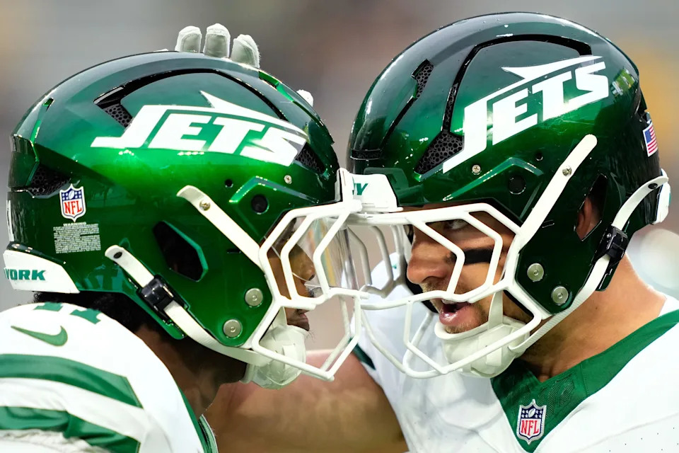 Aug 9, 2025; Green Bay, Wisconsin, USA; New York Jets linebacker Jackson Sirmon (right) talks with New York Jets linebacker Marcelino McCrary-Ball (left) during warmups before a game against the Green Bay Packers at Lambeau Field. Mandatory Credit: Kayla Wolf-Imagn Images