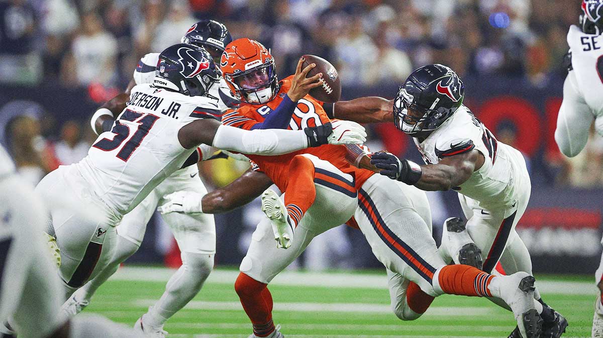 Houston Texans defensive end Will Anderson Jr. (51) and defensive end Danielle Hunter (55) attempt to sack Chicago Bears quarterback Caleb Williams (18) during the first quarter at NRG Stadium. 