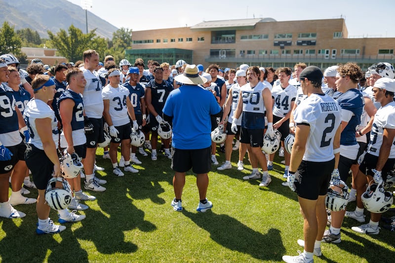 BYU head coach Kalani Sitake huddles up the players during the second day of fall camp in Provo, Thursday, July 31, 2025.