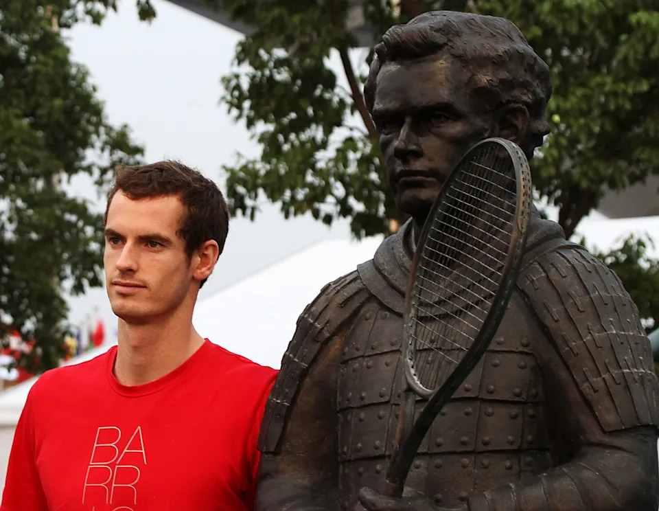 Two-time Wimbledon winner Andy Murray poses next to his statue in the style of a terracotta warrior near a tennis court in Shanghai, China. (Photo by Visual China Group via Getty Images)