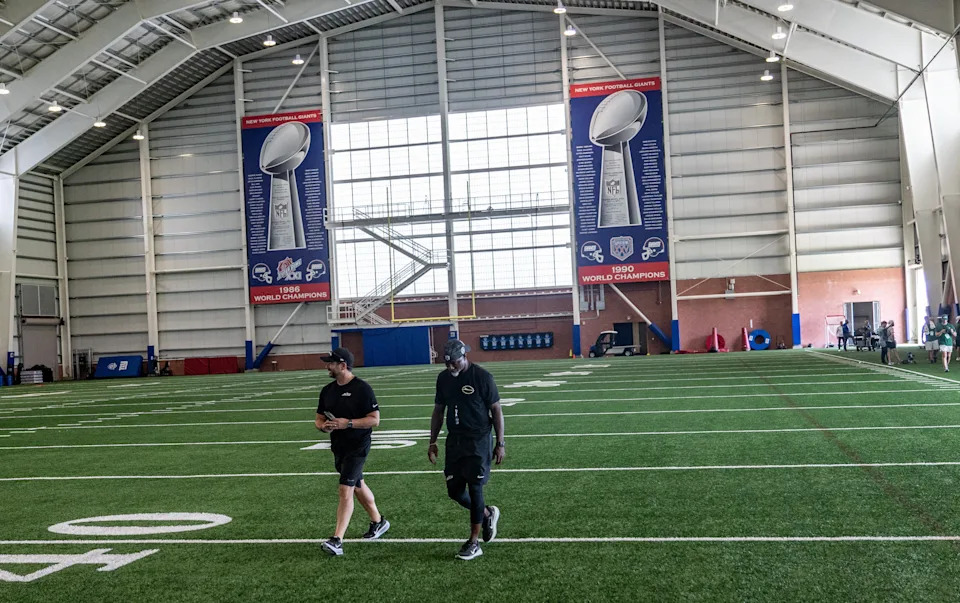 New York Jets head coach Aaron Glenn walks through the field house after a joint training camp practice with the New York Giants, Wednesday, August 13, 2025, in East Rutherford, N.J.