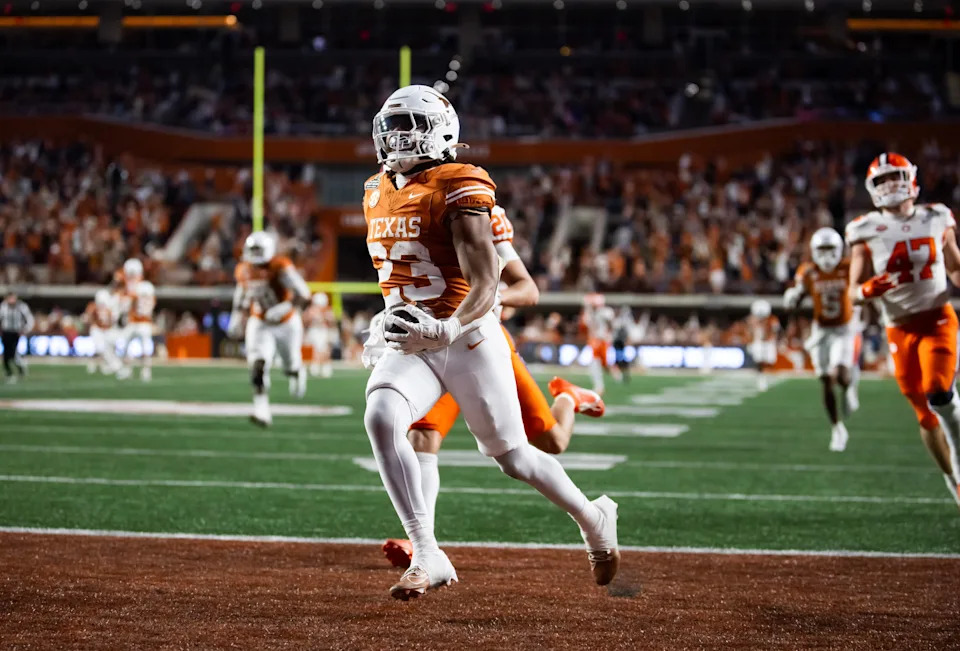 Dec 21, 2024; Austin, Texas, USA; Texas Longhorns running back Jaydon Blue (23) scores a touchdown against the Clemson Tigers during the CFP National playoff first round at Darrell K Royal-Texas Memorial Stadium. Mandatory Credit: Mark J. Rebilas-Imagn Images