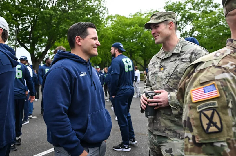 Seahawks coach Mike macdonald with a major from the 1-2 Stryker Brigade Combat Team at Joint Base Lewis-McChord during the team’s visit to the U.S. Army unit June 4, 2024.