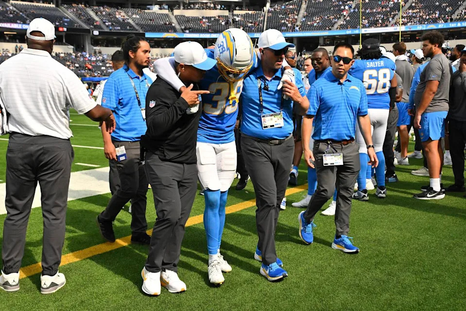 Chargers cornerback Eric Rogers is helped off the field after sustaining injury late in the fourth quarter Sunday.