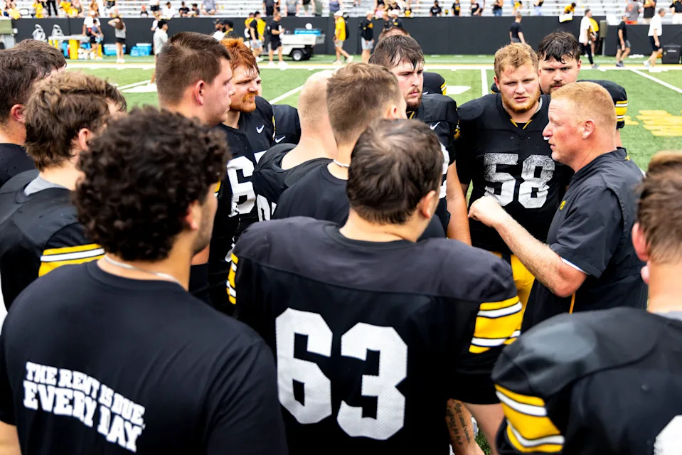 Aug 9, 2025; Iowa offensive line coach George Barnett talks with players during the Hawkeyes Kids Day NCAA football open practice at Kinnick Stadium in Iowa City, Iowa. Mandatory Credit: Joseph Cress for the Des Moines Register