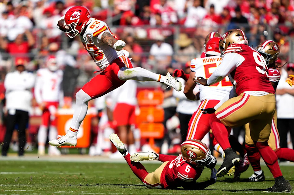 SANTA CLARA, CALIFORNIA - OCTOBER 20: Noah Gray #83 of the Kansas City Chiefs jumps over Malik Mustapha #6 of the San Francisco 49ers in the first quarter at Levi's Stadium on October 20, 2024 in Santa Clara, California. (Photo by Thearon W. Henderson/Getty Images)