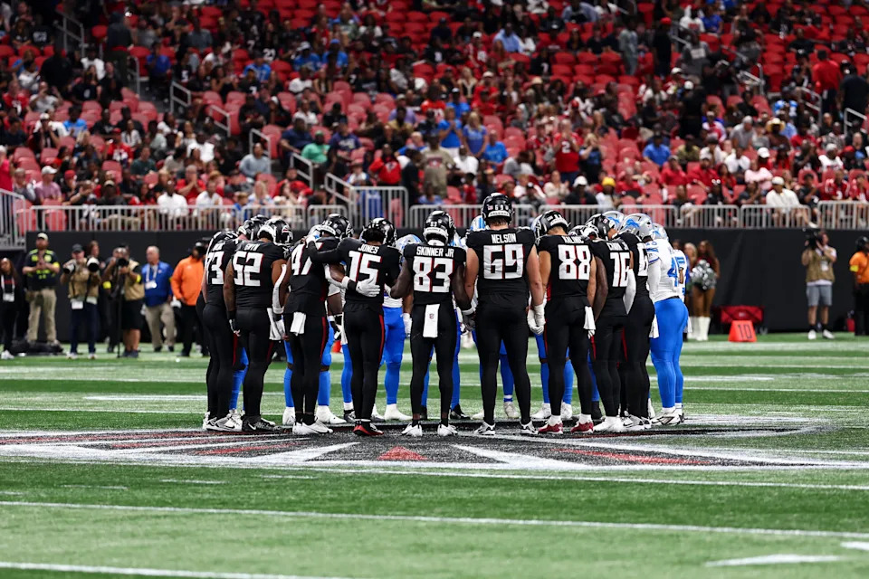 ATLANTA, GEORGIA - AUGUST 8: Atlanta Falcons and Detroit Lions players hold hands at midfield after Morice Norris #26 of the Detroit Lions sustained an injury during the fourth quarter of an NFL preseason football game at Mercedes-Benz Stadium on August 8, 2025 in Atlanta, Georgia. (Photo by Kevin Sabitus/Getty Images)