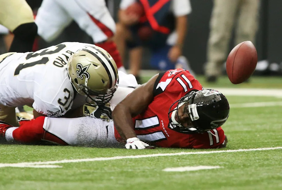 Sep 7, 2014; Atlanta, GA, USA; Atlanta Falcons wide receiver Julio Jones (11) fumbles the ball after a hit by New Orleans Saints free safety Jairus Byrd (31) in the first half of their game at the Georgia Dome. The Saints recovered the ball in the end zone. Mandatory Credit: Jason Getz-USA TODAY Sports