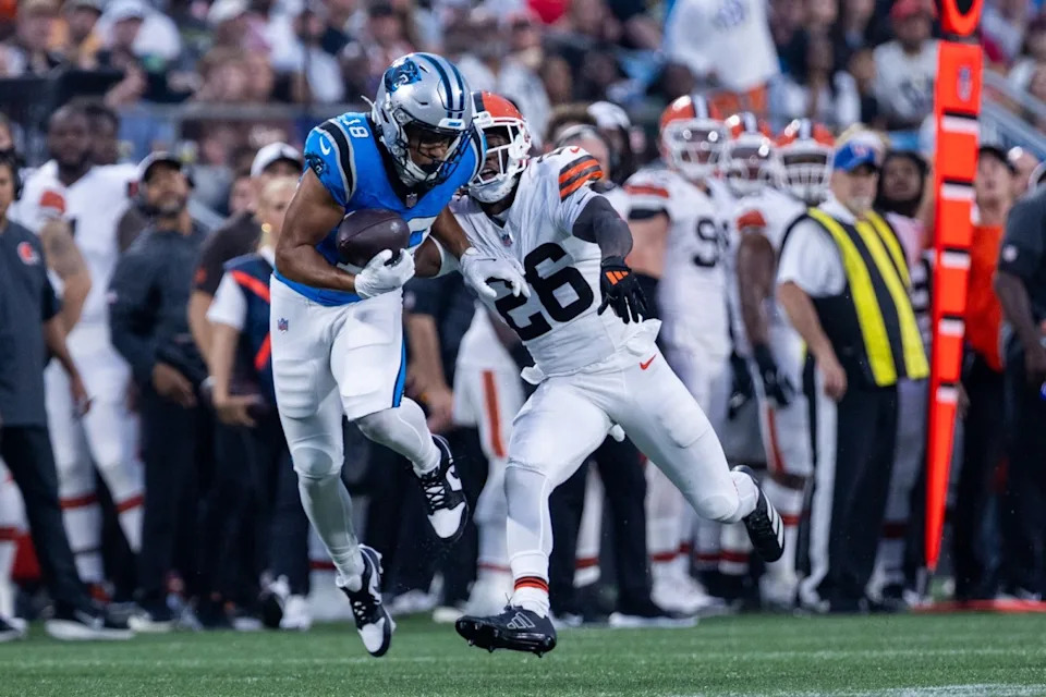 Aug 8, 2025; Charlotte, North Carolina, USA; Carolina Panthers wide receiver Jalen Coker (18) makes the catch over Cleveland Browns cornerback Myles Harden (26) during the second quarter at Bank of America Stadium. © Scott Kinser-The USAToday Network via Imagn Images