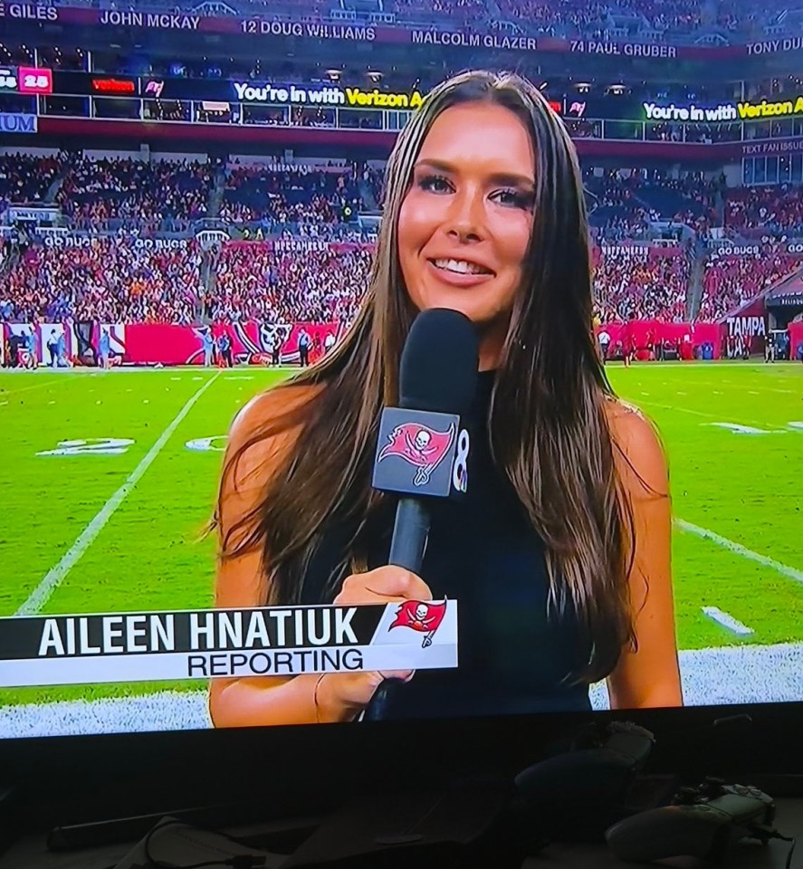 Aileen Hnatiuk reporting from a football stadium.