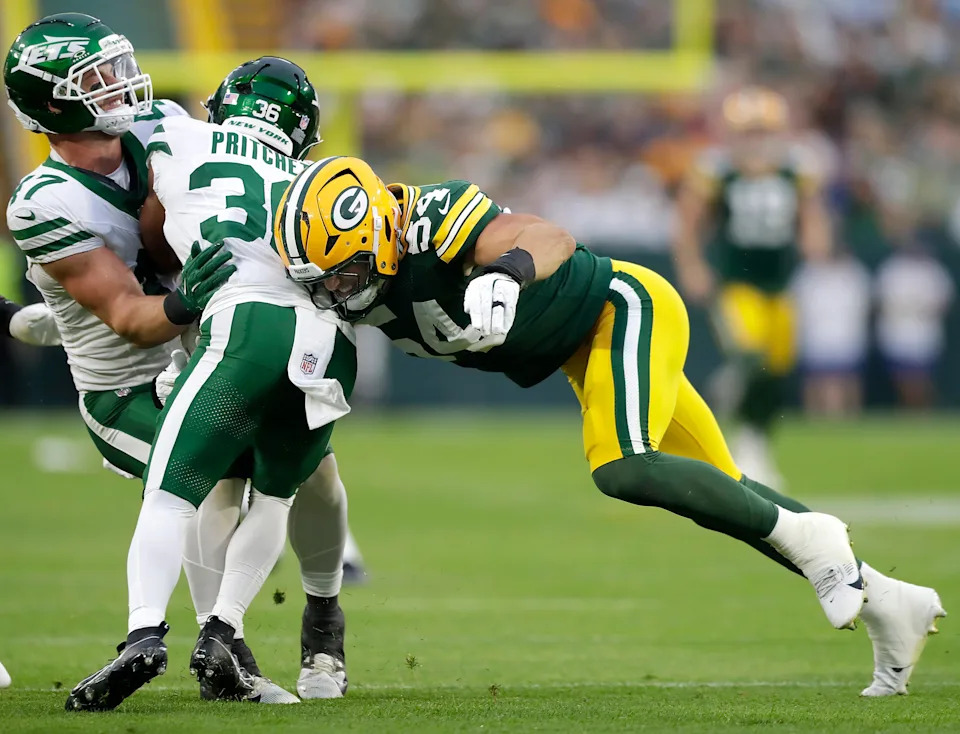 Green Bay Packers linebacker Kristian Welch tackles New York Jets wide receiver Jamaal Pritchett.