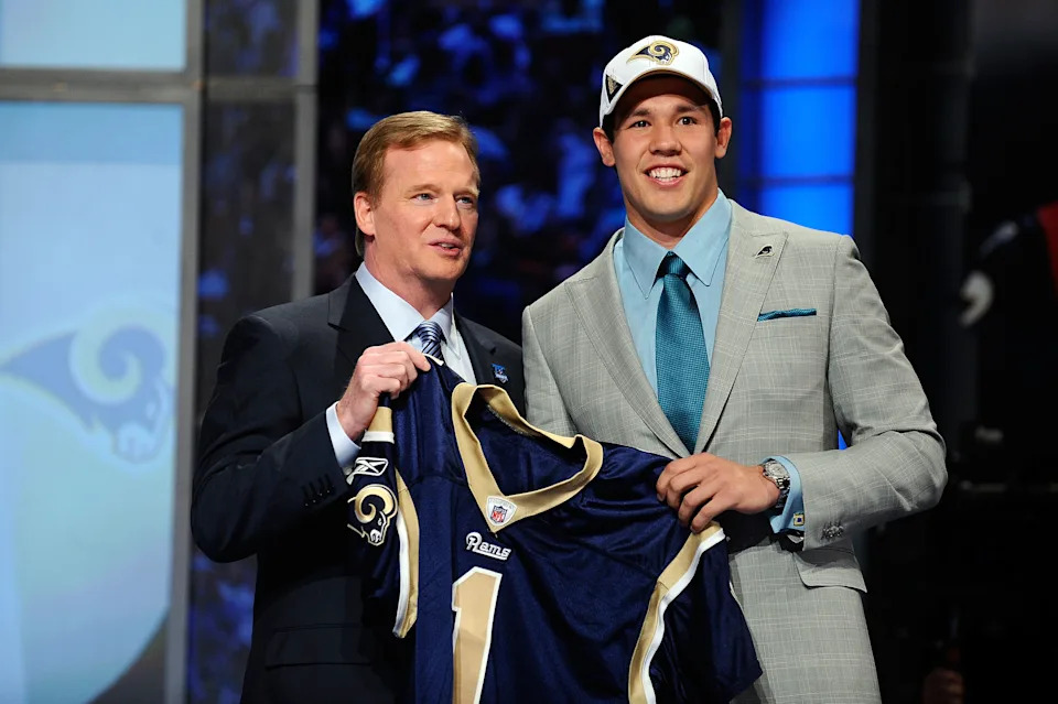 NEW YORK - APRIL 22:  Quarterback Sam Bradford of the Oklahoma Sooners holds up a St. Louis Rams jersey as he stands with NFL Commissioner Roger Goodell after Bradford was picked numer 1 overall by the Rams during the 2010 NFL Draft at Radio City Music Hall on April 22, 2010 in New York City.  (Photo by Jeff Zelevansky/Getty Images)