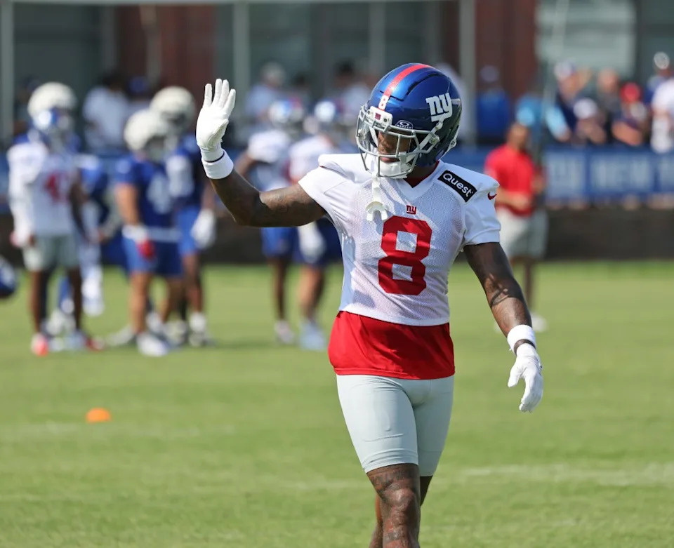 Jevon Holland waves to the fans during practice at the Giants training facility. Charles Wenzelberg / New York Post