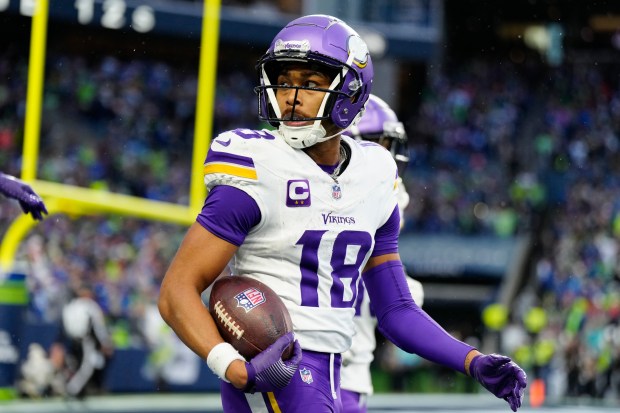 Minnesota Vikings wide receiver Justin Jefferson (18) looks on after scoring a touchdown during an NFL football game against the Seattle Seahawks, Sunday, Dec. 22, 2024 in Seattle. The Vikings defeated the Seahawks 27-24. (AP Photo/Ben VanHouten)