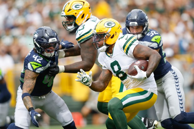 Green Bay Packers running back Josh Jacobs (8) runs the ball against the Seattle Seahawks during a preseason NFL football game Saturday, Aug. 23, 2025, in Green Bay, Wis. (AP Photo/Jeffrey Phelps