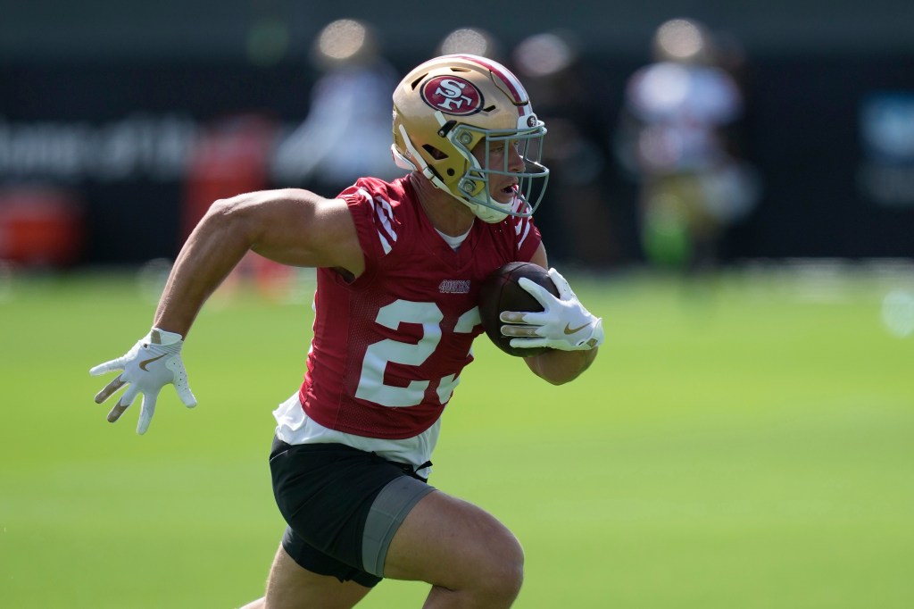 Christian McCaffrey running with a football.